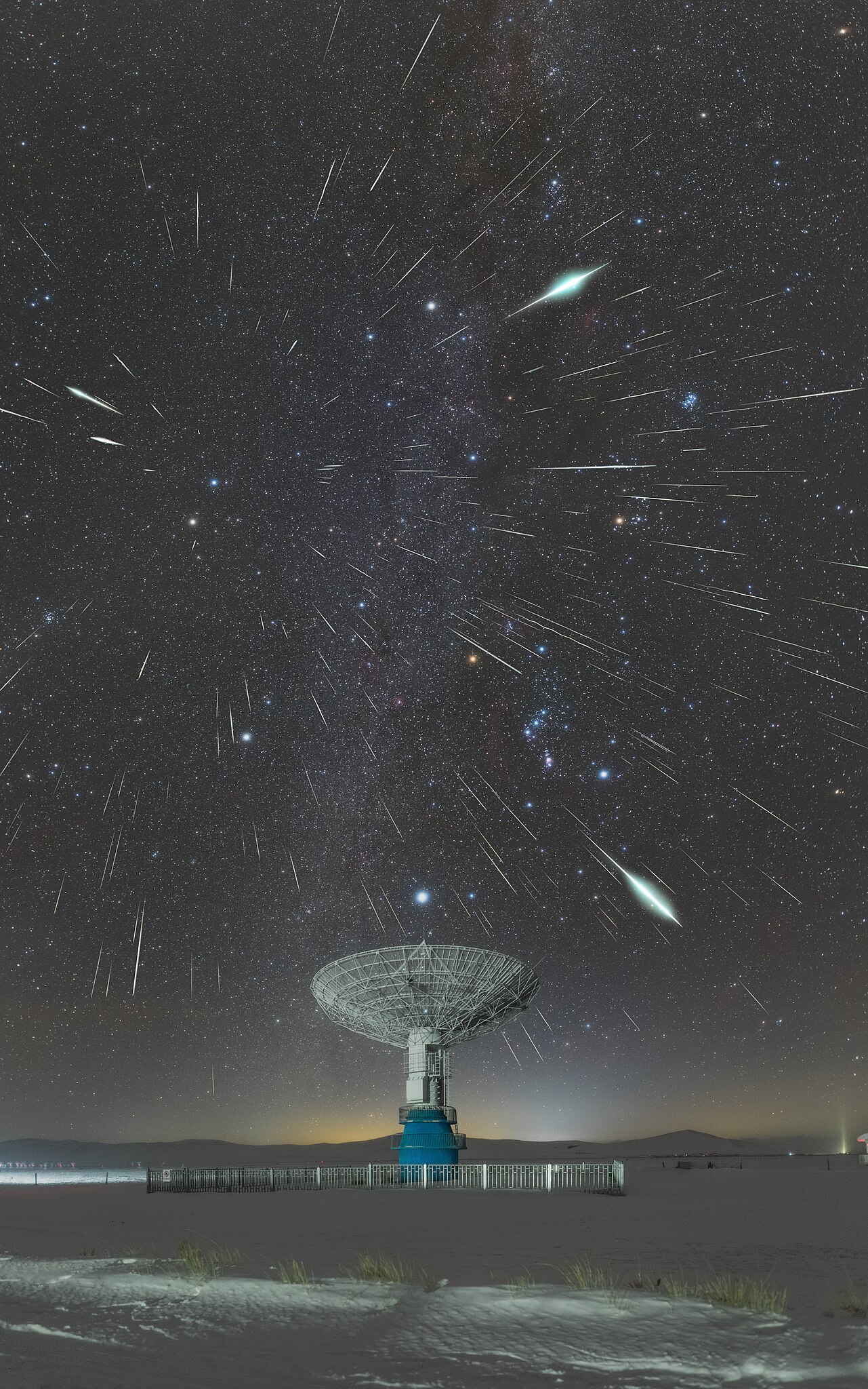 A telescope with a bright night sky, filled with meteors moving out from a radial point 