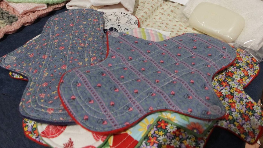 A number of brightly coloured handmade sanitary pads on a table