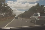 An SUV overtaking a car on the right side of the road.