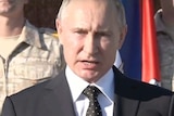 Russian President Vladimir Putin speaks on TV.