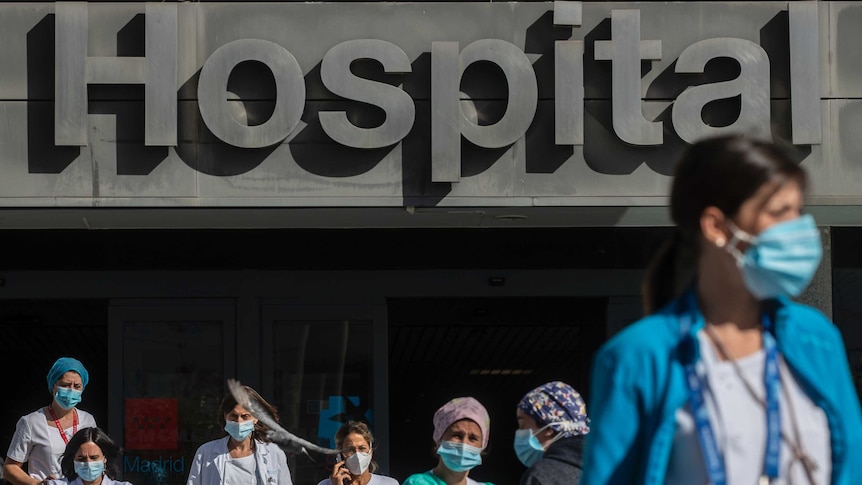 Medical staff and nurses wearing face masks to prevent the spread of coronavirus gather during a protest.