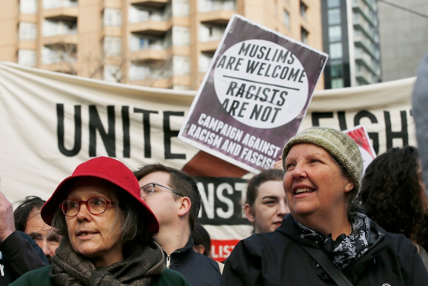 A protest with a sign saying 'Muslims are welcome, racists are not'