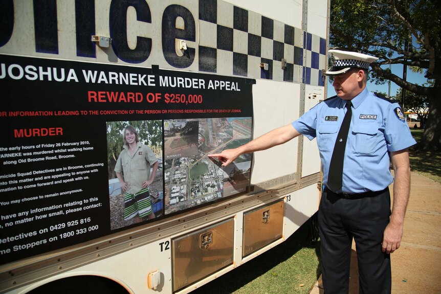Acting Detective Superintendent Pete Branchi points to a map on a police truck showing information on John Warneke's murder.