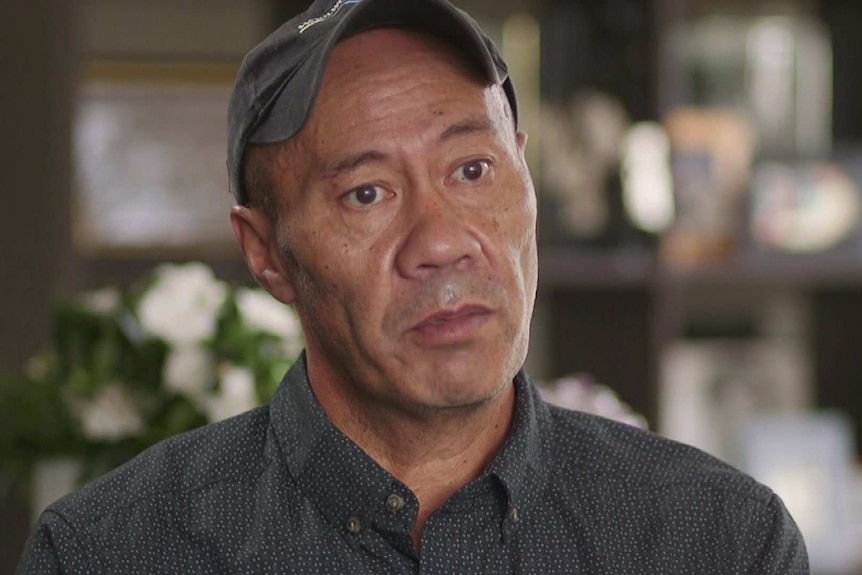 Head shot of Kim Joyce wearing black cap and dark shirt with small white dots.