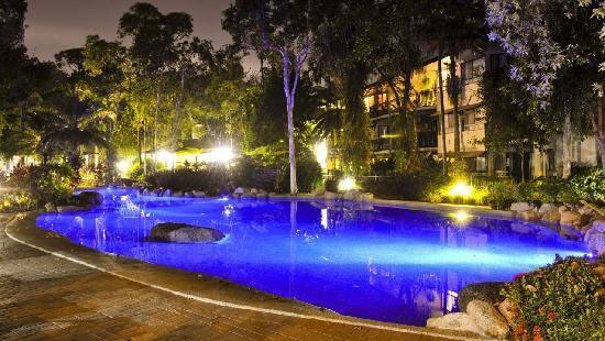 Night time shot of lit pool at Trinity Lakes Resort in Cairns.