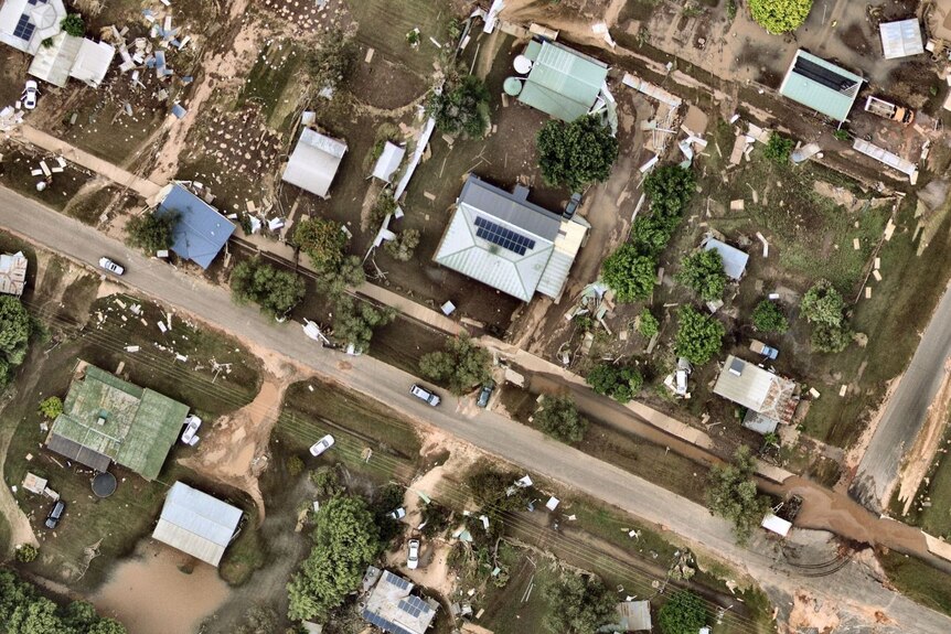 An aerial view of a country town severely impacted by a flash flood.