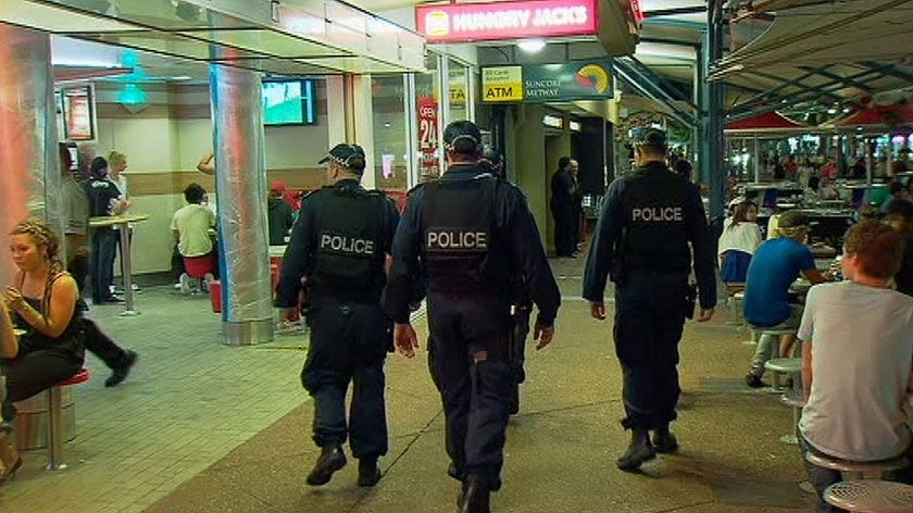 TV still of three police officers on patrol at schoolies celebrations at night at Surfers Paradise