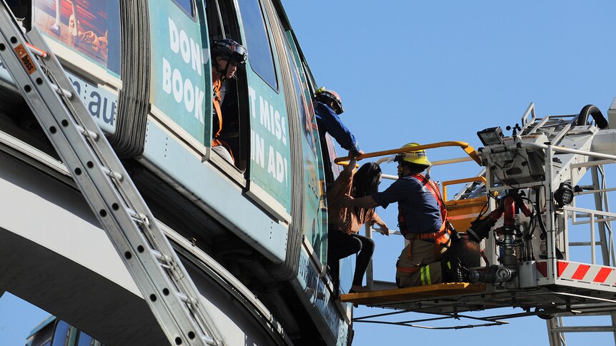 Crews rescue passengers from the stranded monorail in Sydney on September 24, 2012.