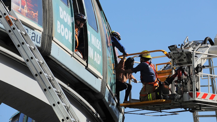 Crews rescue passengers from the stranded monorail in Sydney on September 24, 2012.
