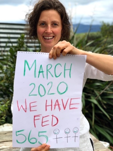 woman holding sold out sign