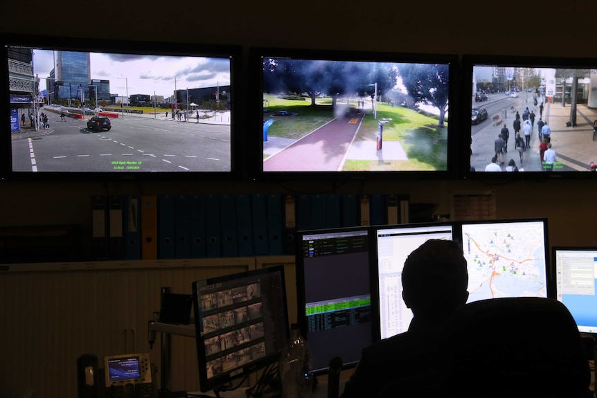 An unidentified auxiliary police officer monitors CCTV cameras at the CityWatch surveillance centre in Perth.