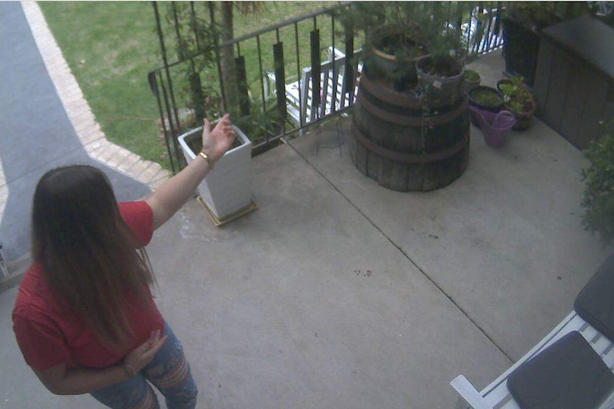 A woman outside the front door of a private home