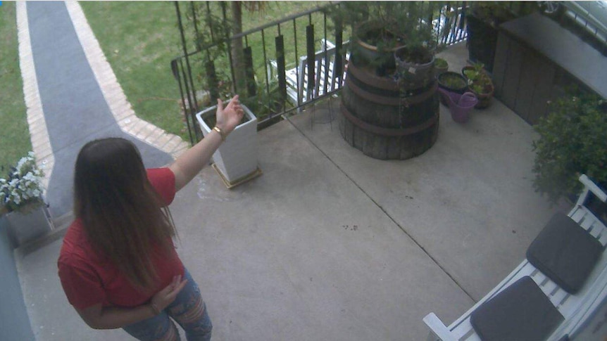 A woman outside the front door of a private home