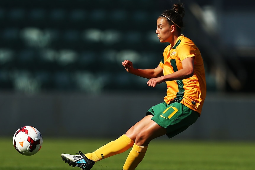 Chloe Logarzo of Australia kicks a ball during a match against CHina in 2013