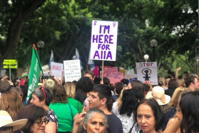 A placard that reads: I'm here for Aiia