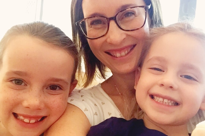 Renee Wilson smiling with daughters Ava and Isla, she supports her daughters' interest in traditional gender expression.