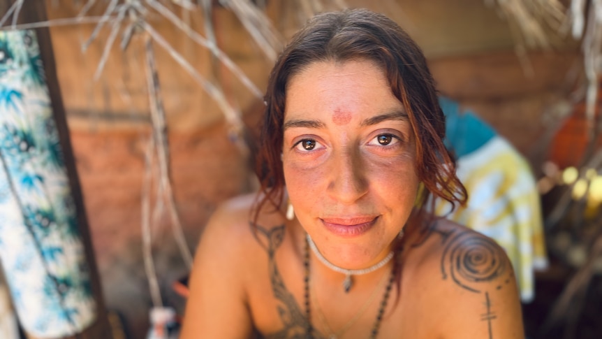 A woman with brown hair stares soulfully at the camera.