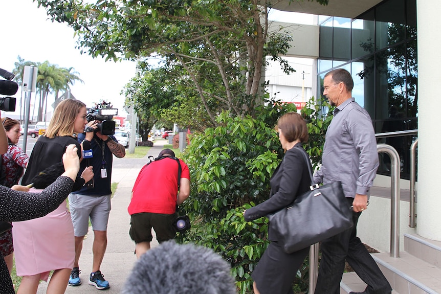 Swim coach Scott Volkers leaves Maroochydore Magistrates Court with his lawyer on Queensland's Sunshine Coast