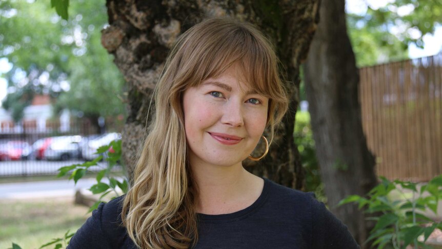 Lily Dempster standing in front of a tree