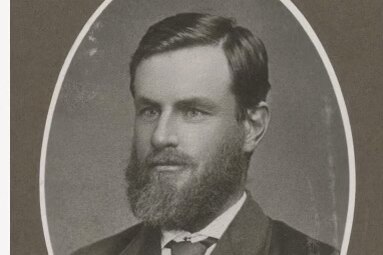 Old black and white photo of a bearded man dressed in a suit.
