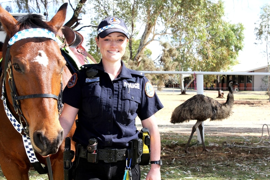 Constable Sharrah Blenkinsop from Alice Springs mounted police, with emu in background.