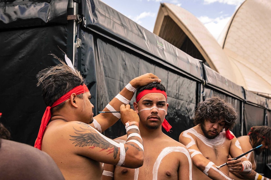 Colour photo of Nunukul Yuggera dancers getting ready backstage at Dance Rites 2018 at Sydney Opera House.
