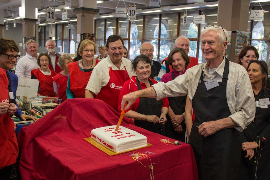 Volunteer organiser Rob Rippingale cuts the cake, 15 August 2014