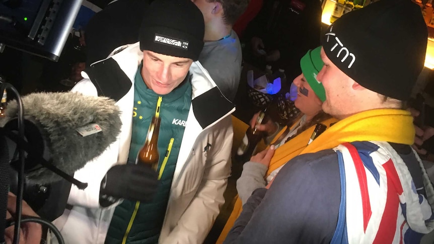 Matt Graham celebrates at a bar in Pyeongchang after winning a silver medal in the men's moguls.