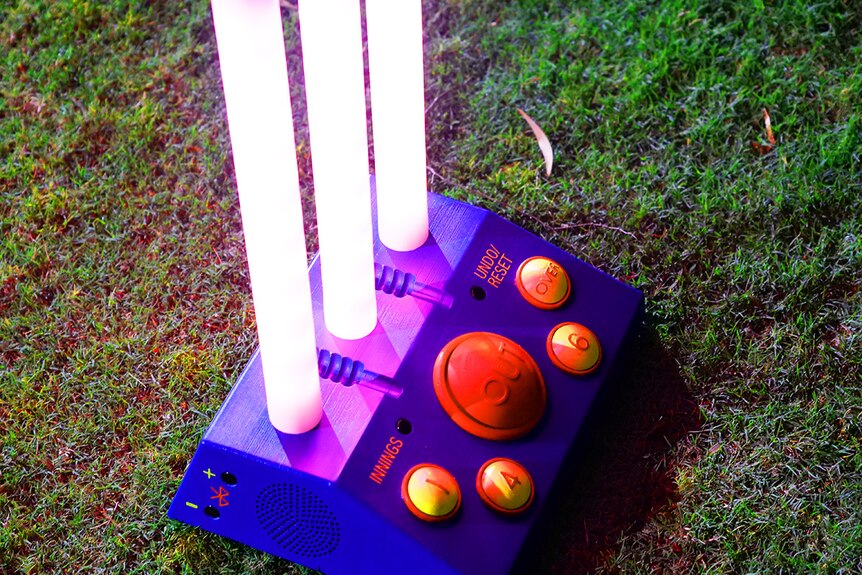 A home-made computerised cricket wicket lights up.