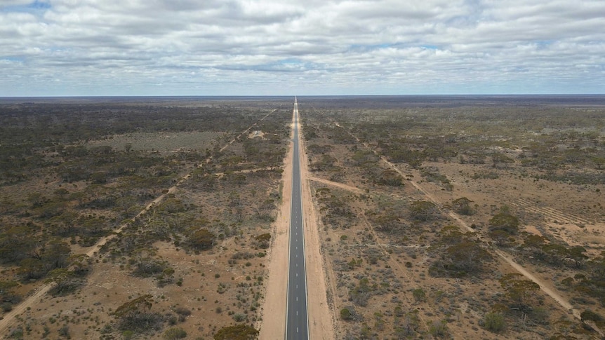 A road stretches off into the horizon.