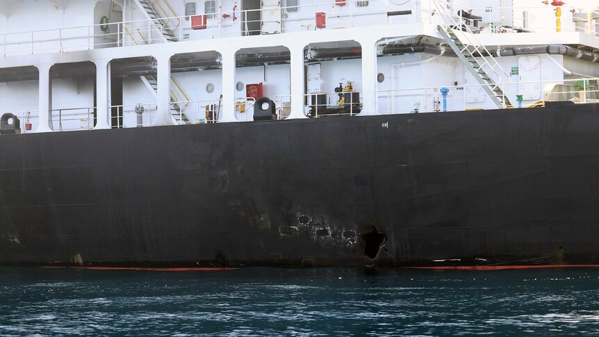 Image shows holes in the side of a tanker at sea