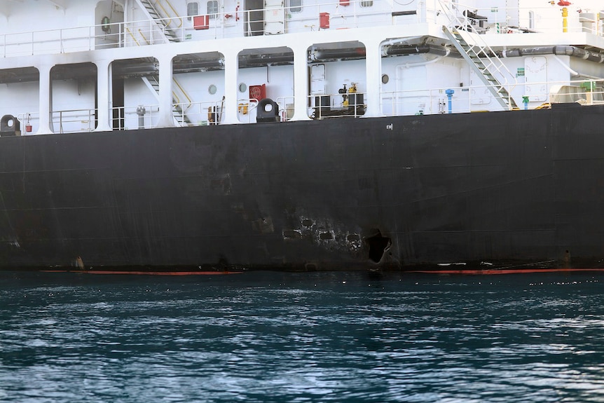 Image shows holes in the side of a tanker at sea