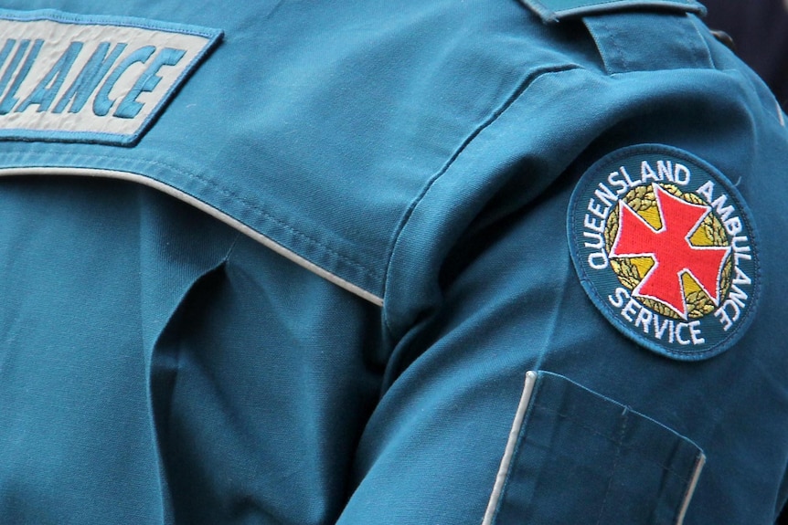 Queensland Ambulance Service emblem on the shoulder of an officer on a job.