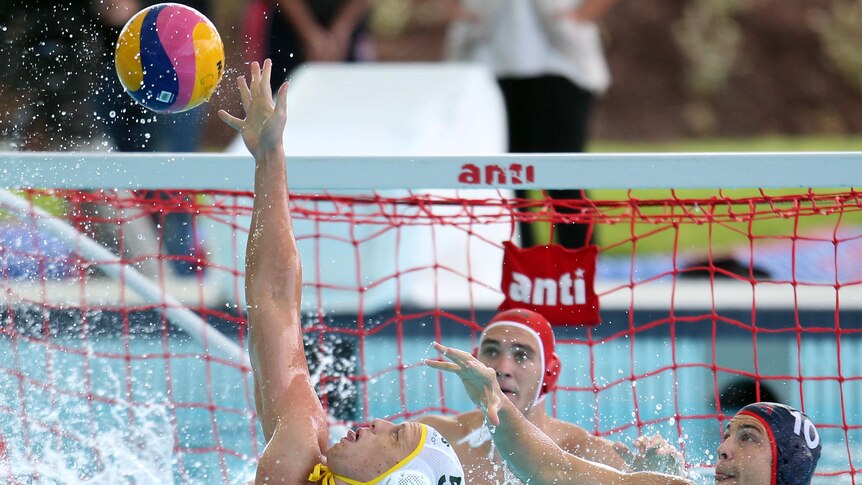 Jamie Beadsworth reaches to block a USA pass at the Water Polo Pan Pacs in Melbourne.