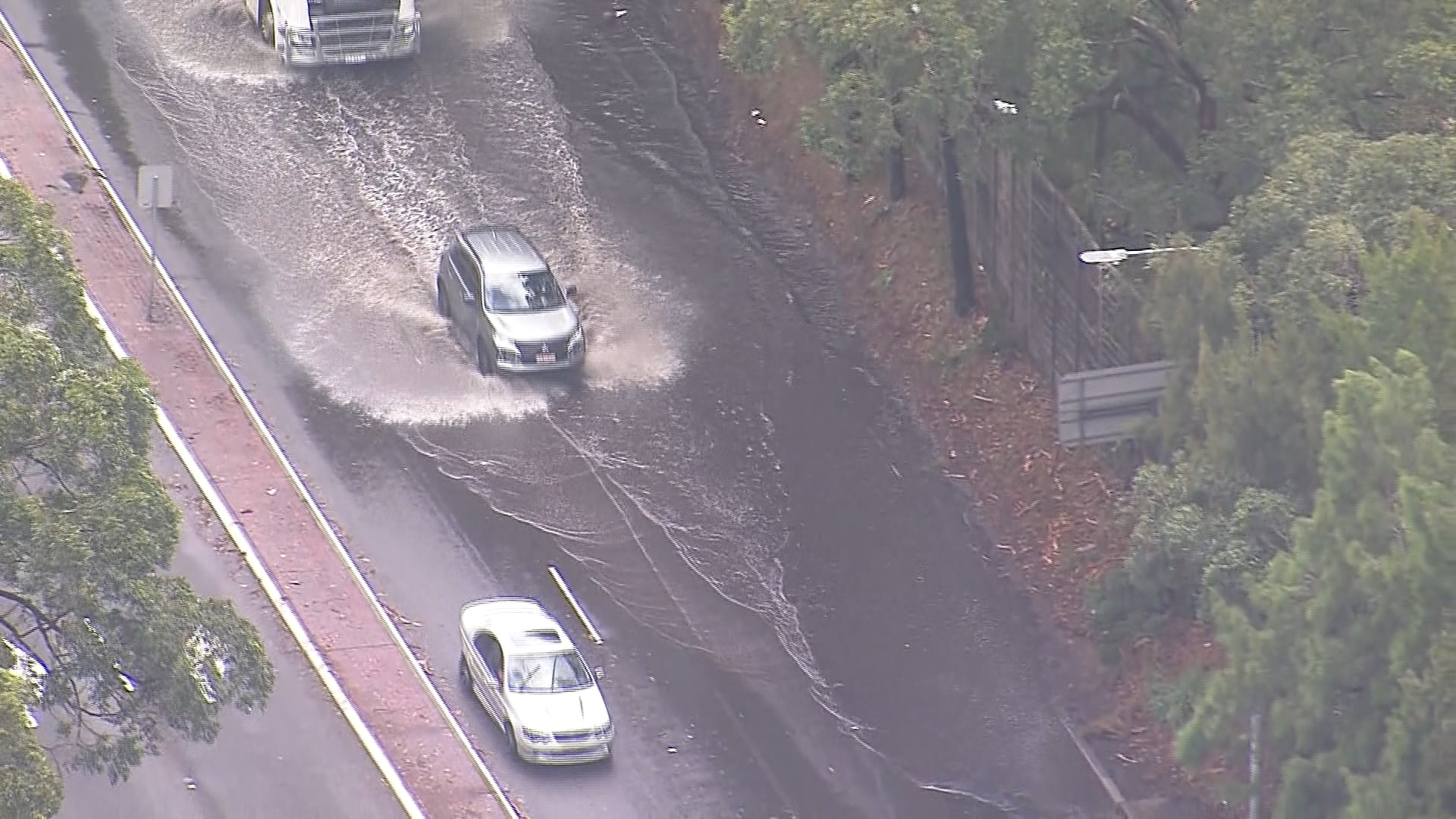 Four flood rescues across NSW as severe storms lash state