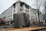 A rocket fragment lies on the ground next to a building of Ukrainian Security Service.