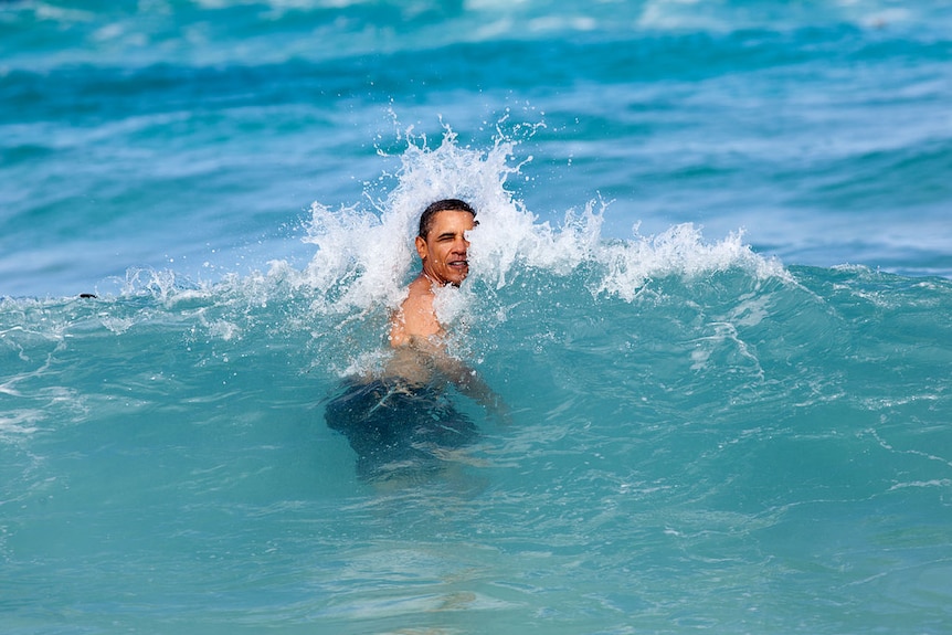 President Barack Obama hit by a wave in Hawaii