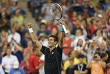 Novak Djokovic of Serbia waves to the crowd after his victory over Joao Sousa of Portugal.