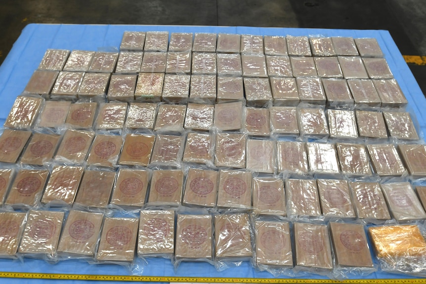 Packets of heroin laid out on a table.