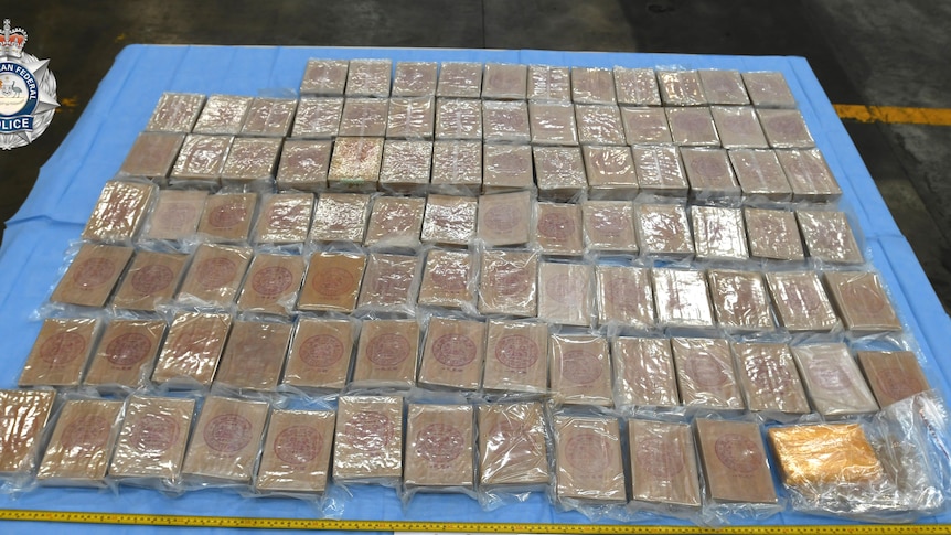 Packets of heroin laid out on a table.