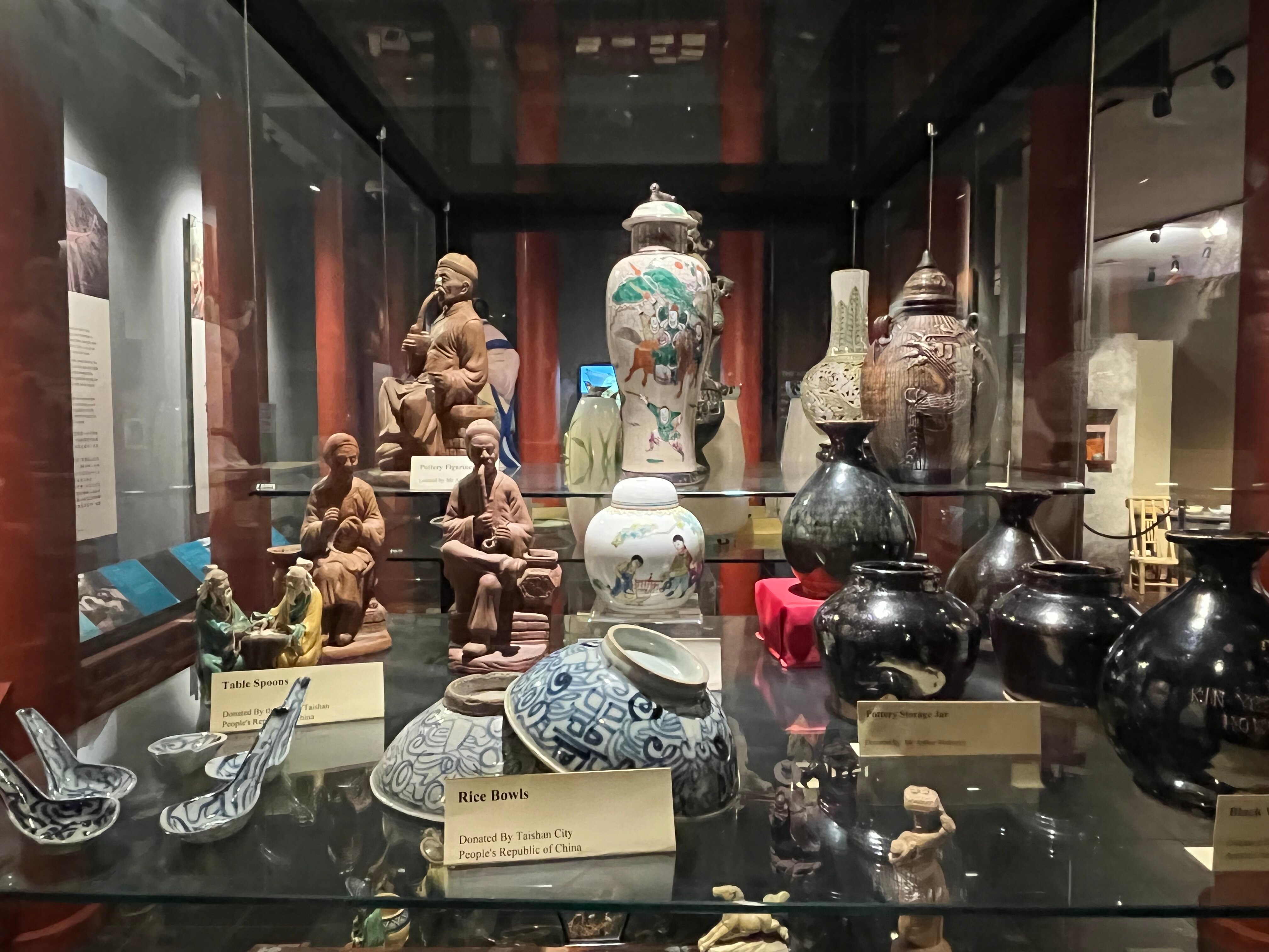 A glass display of historical Chinese artefacts and culture.