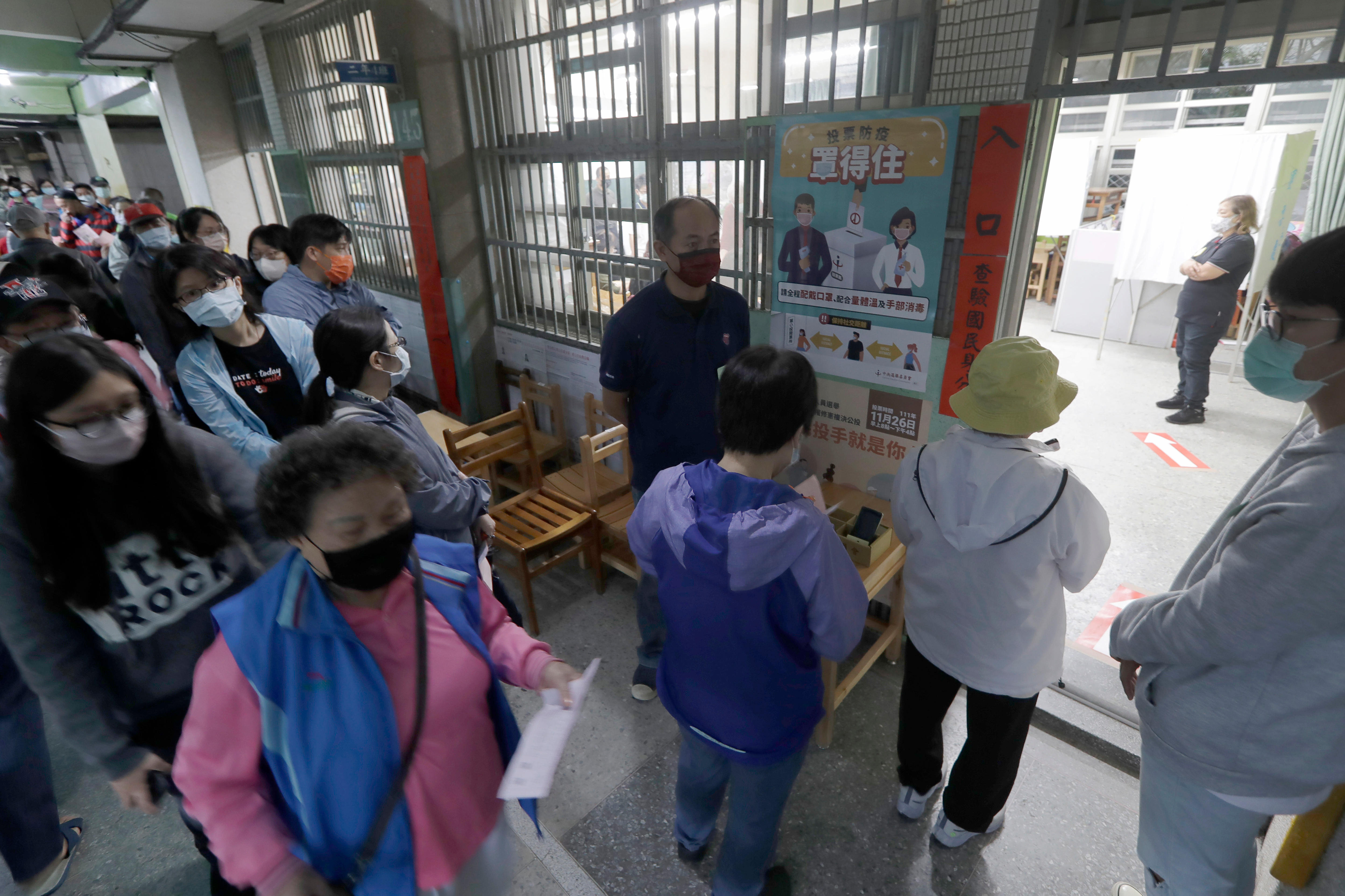 People line up to cast ballots at polling station.