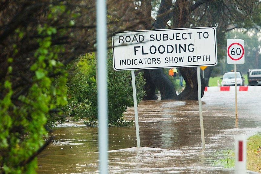 Flooding hits Tasmanian town Forth, a road is shown completely underwater.