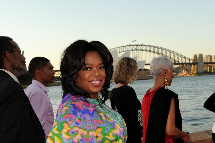 Oprah Winfrey in front of the Opera House and Harbour Bridge in Sydney.