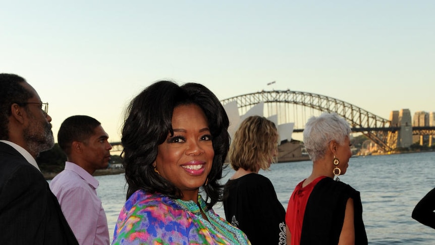 Oprah Winfrey in front of the Opera House and Harbour Bridge in Sydney.