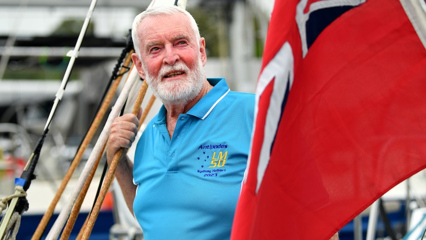 Lindsay May looks on as he stands on a yacht near a NSW flag