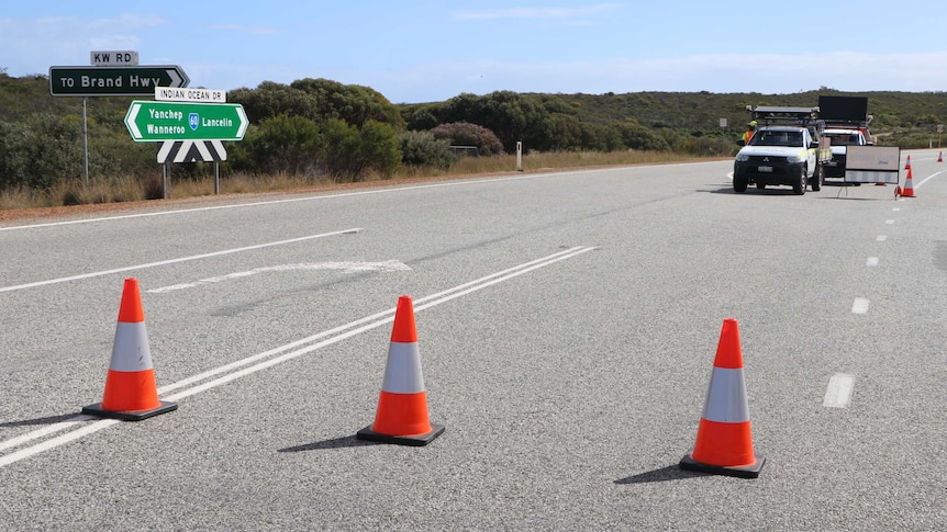 Emergency cones stretch across Indian Ocean Drive, with trucks in the background.