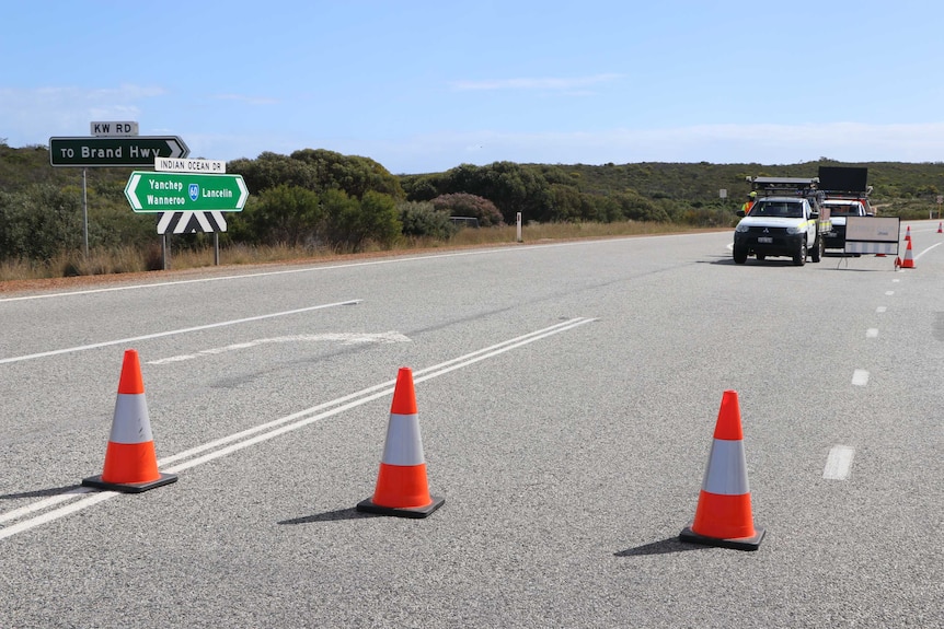 Emergency cones stretch across Indian Ocean Drive, with trucks in the background.