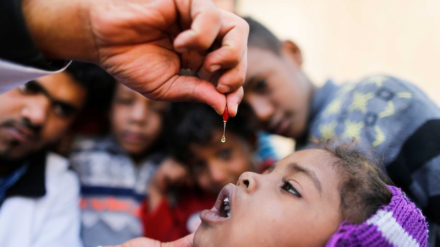 A little girl receives her vitamins in Yemen