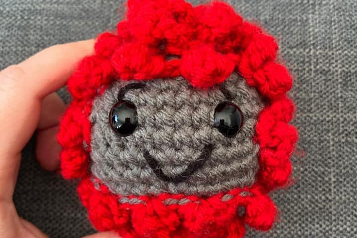 A crochet in the shape of a coronavirus cell.